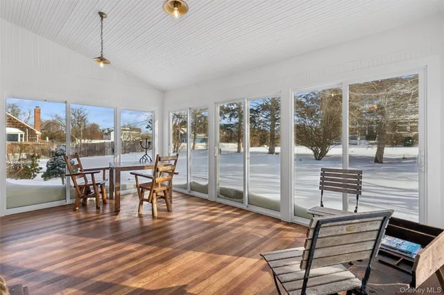 a dining room with furniture window and wooden floor