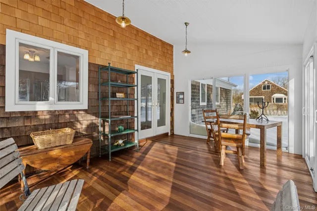 a dining room with furniture and wooden floor