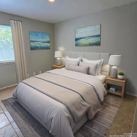 a bedroom with a bed and a painting on the wall