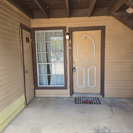 a view of a door of a house with a wooden door