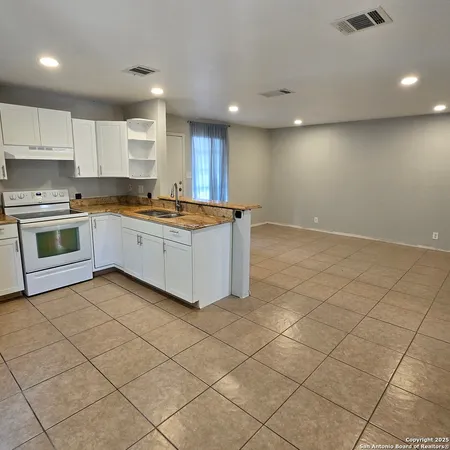 a kitchen with stainless steel appliances granite countertop a sink and cabinets