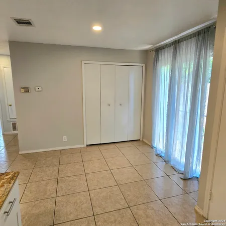 a view of a livingroom with an empty space and a window