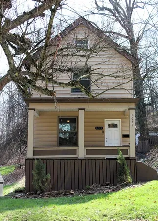 a front view of a house with yard and garage