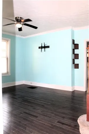 a view of a room with wooden floor