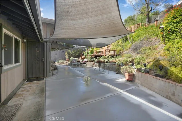a view of a patio with table and chairs and potted plants