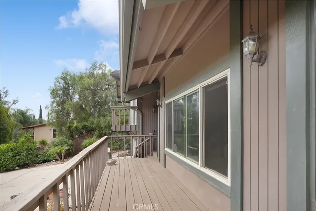 a view of balcony with wooden floor and fence