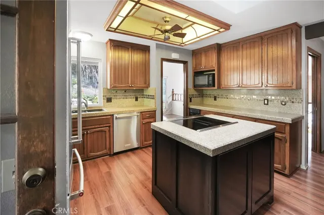 a kitchen with a sink a stove and cabinets