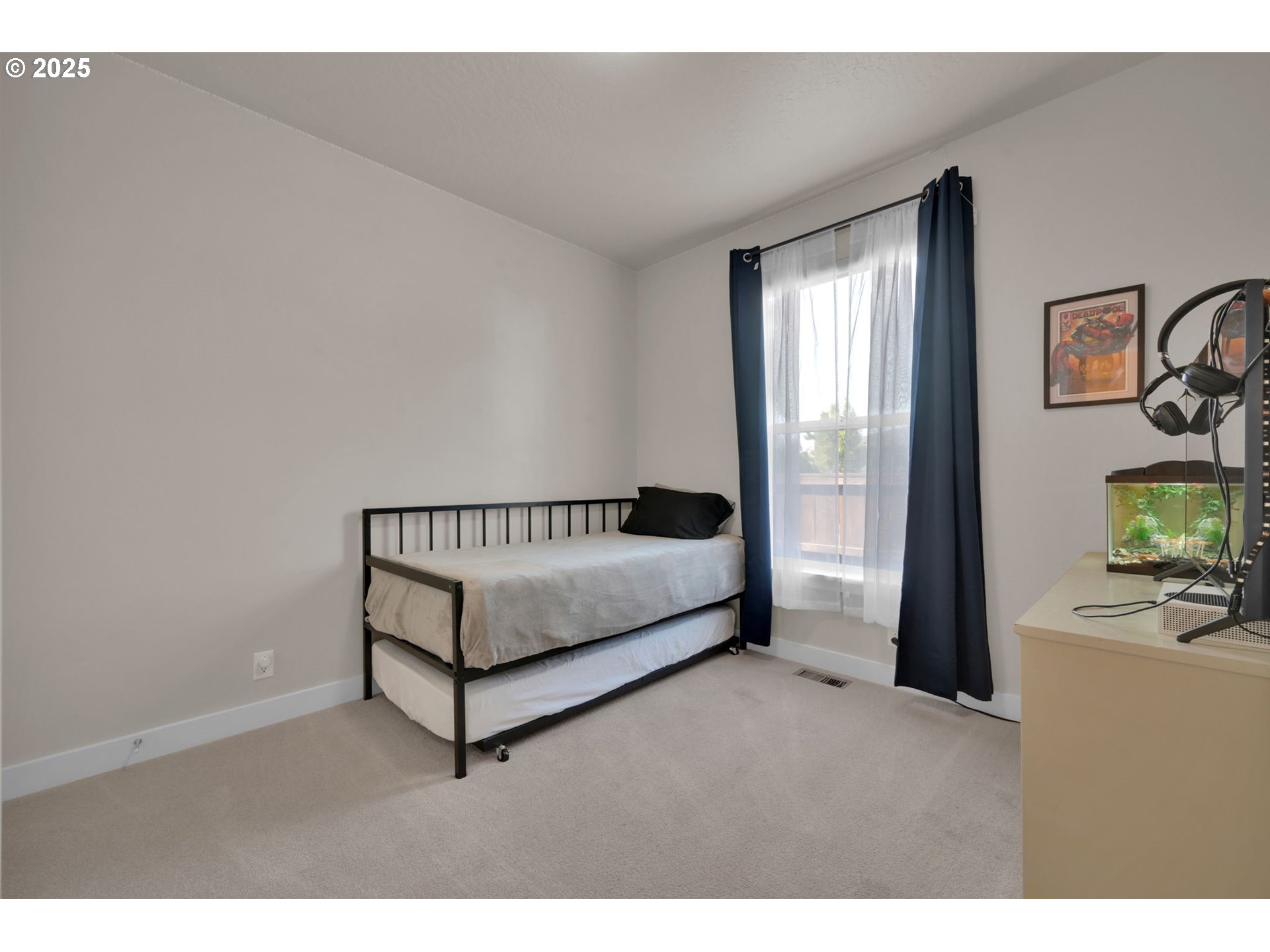 1004 South 46th Street Springfield, OR 97478 - Photo 24 of 34 a spacious bedroom with a bed and a flat screen tv