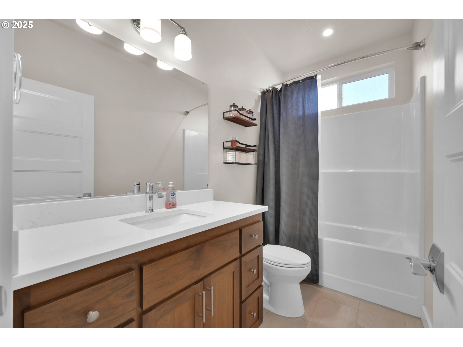 1004 South 46th Street Springfield, OR 97478 - Photo 26 of 34 a bathroom with a sink a toilet and a mirror