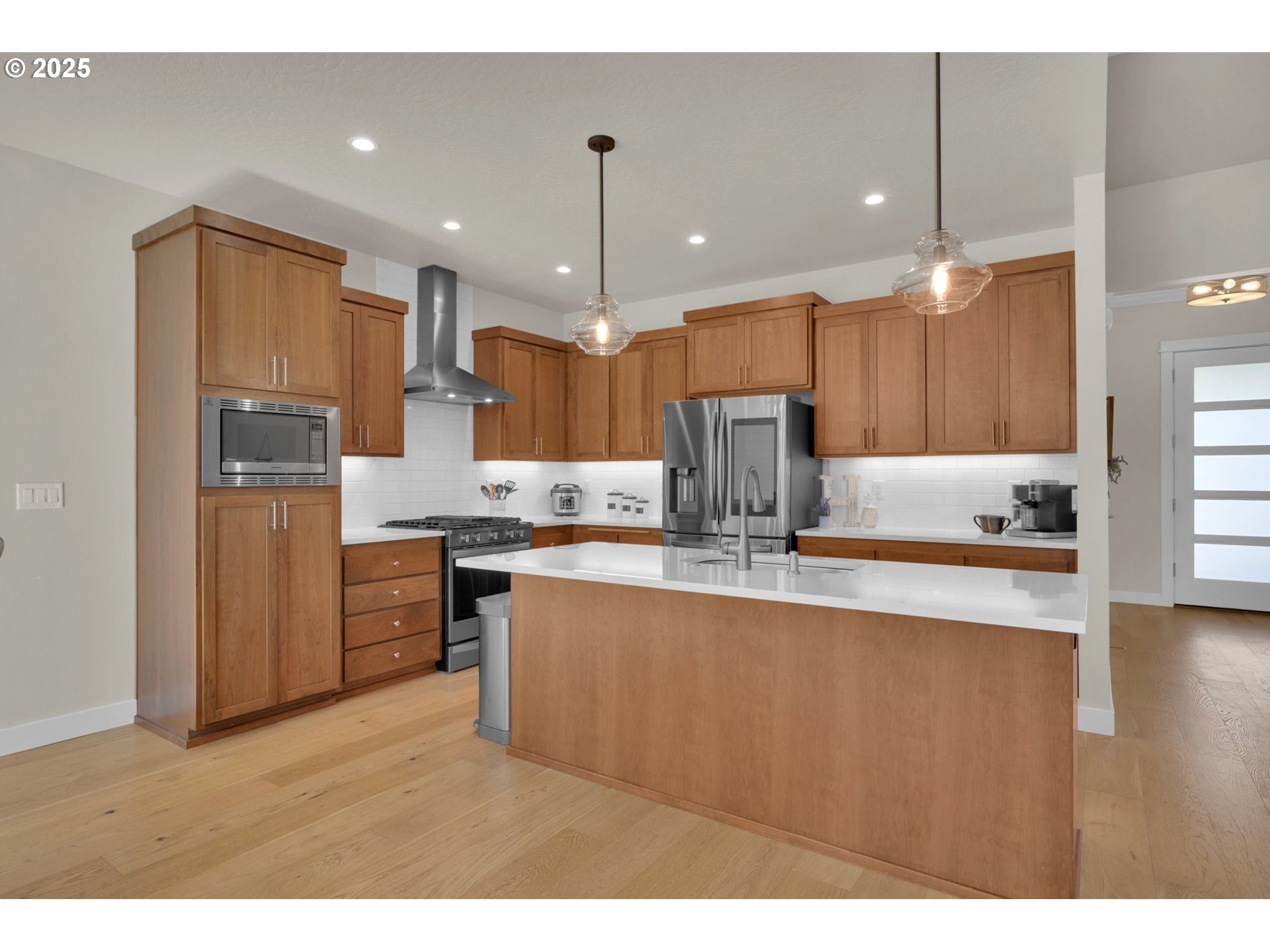 1004 South 46th Street Springfield, OR 97478 - Photo 9 of 34 a kitchen with stainless steel appliances kitchen island granite countertop a refrigerator a sink dishwasher and a stove with wooden floor