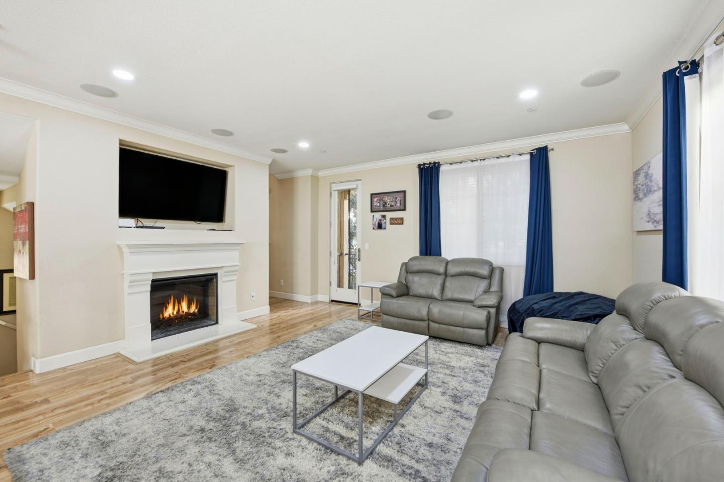 56 Regency Place Hayward, CA 94544 - Photo 10 of 43 a living room with furniture a flat screen tv and a fireplace