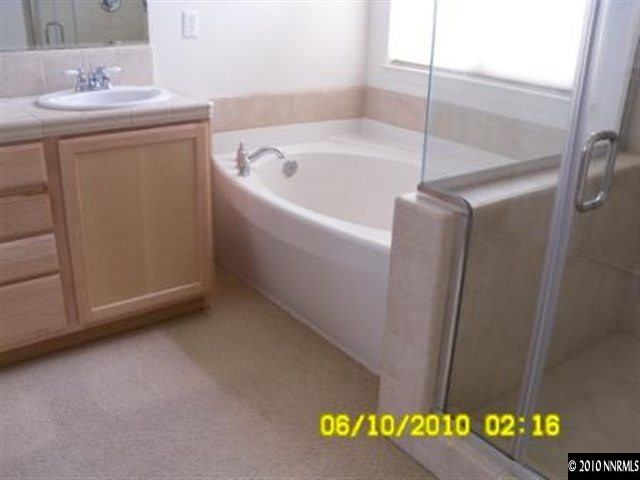 2448 Spring Flower Drive Reno, NV 89521 - Photo 9 of 9 a bathroom with a bathtub and a sink