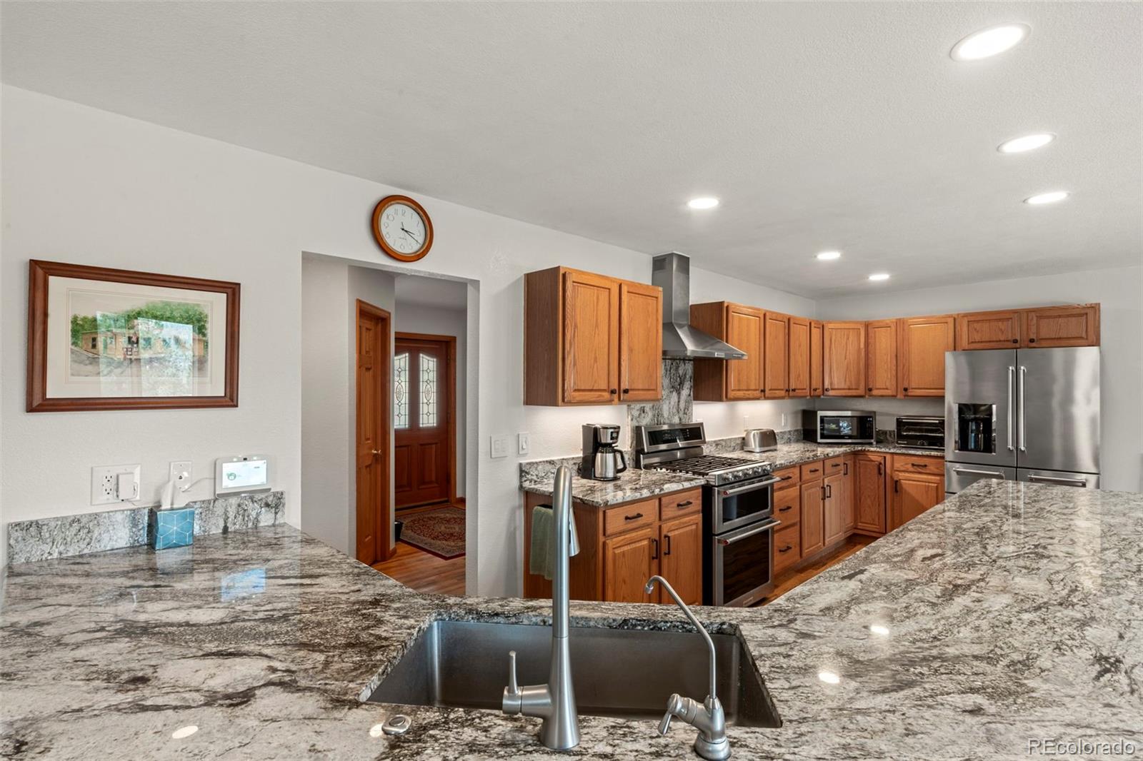 84 Marys Lane Bailey, CO 80421 - Photo 5 of 35 a kitchen with kitchen island granite countertop a stove top oven a sink a counter top space and cabinets