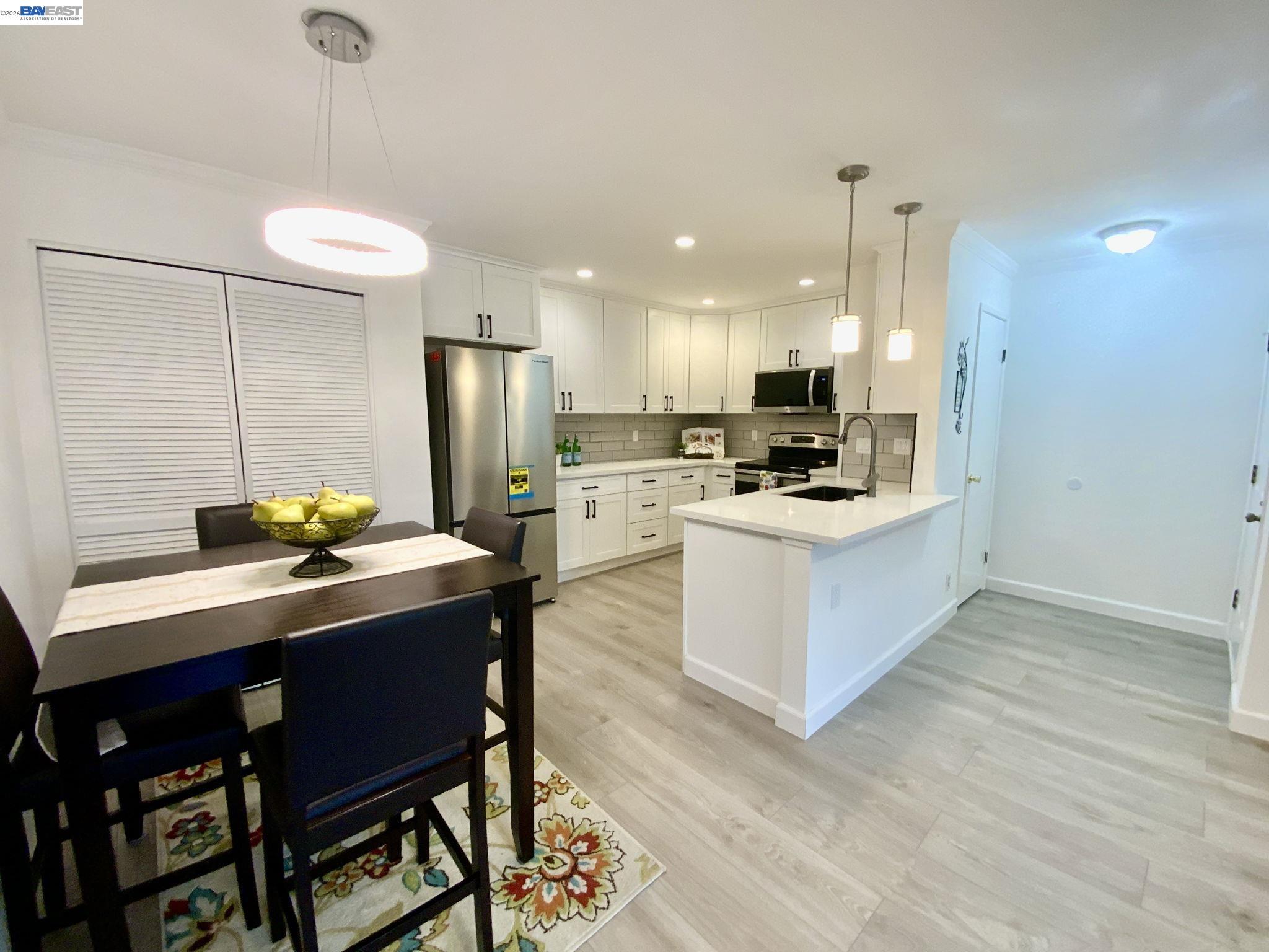 a kitchen with stainless steel appliances granite countertop a stove refrigerator and a sink