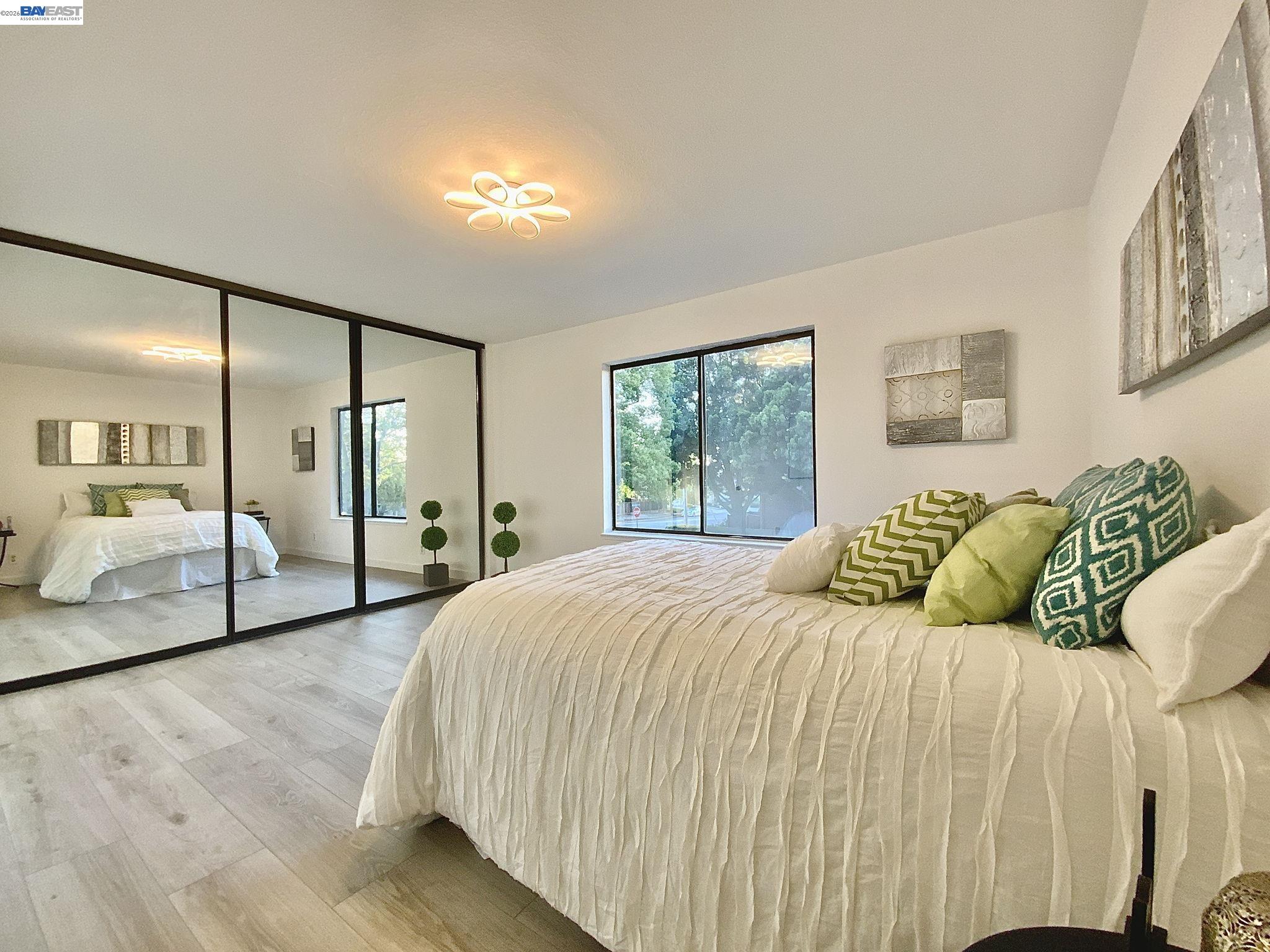 304 Hackamore Lane Fremont, CA 94539 - Photo 13 of 45 a bedroom with a large bed and a chandelier