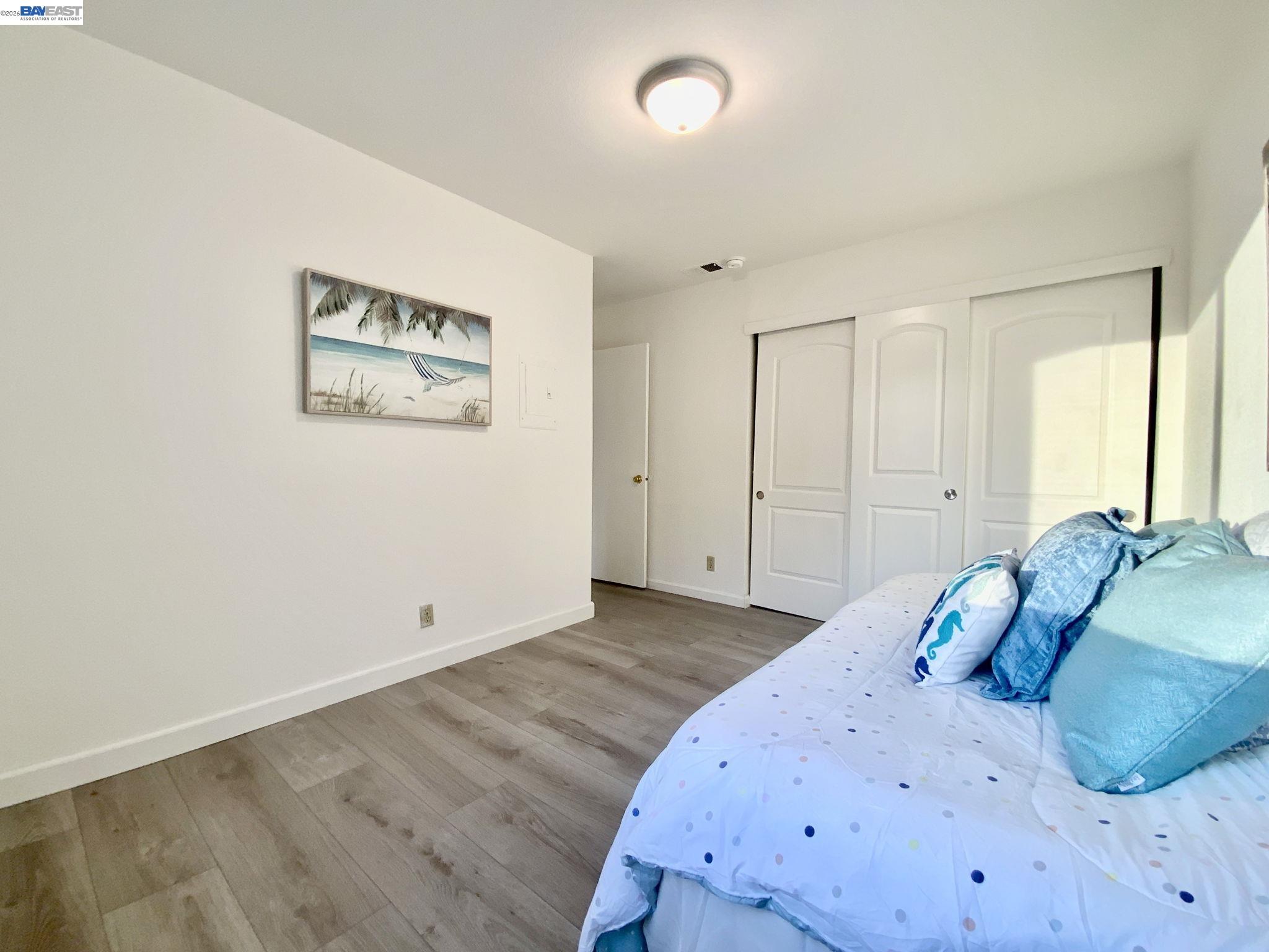 304 Hackamore Lane Fremont, CA 94539 - Photo 16 of 45 a bedroom with a bed and a painting on the wall