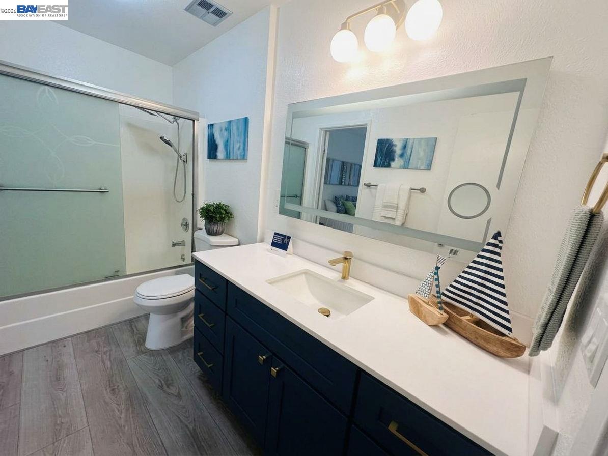 304 Hackamore Lane Fremont, CA 94539 - Photo 19 of 45 a bathroom with a double vanity sink toilet and mirror