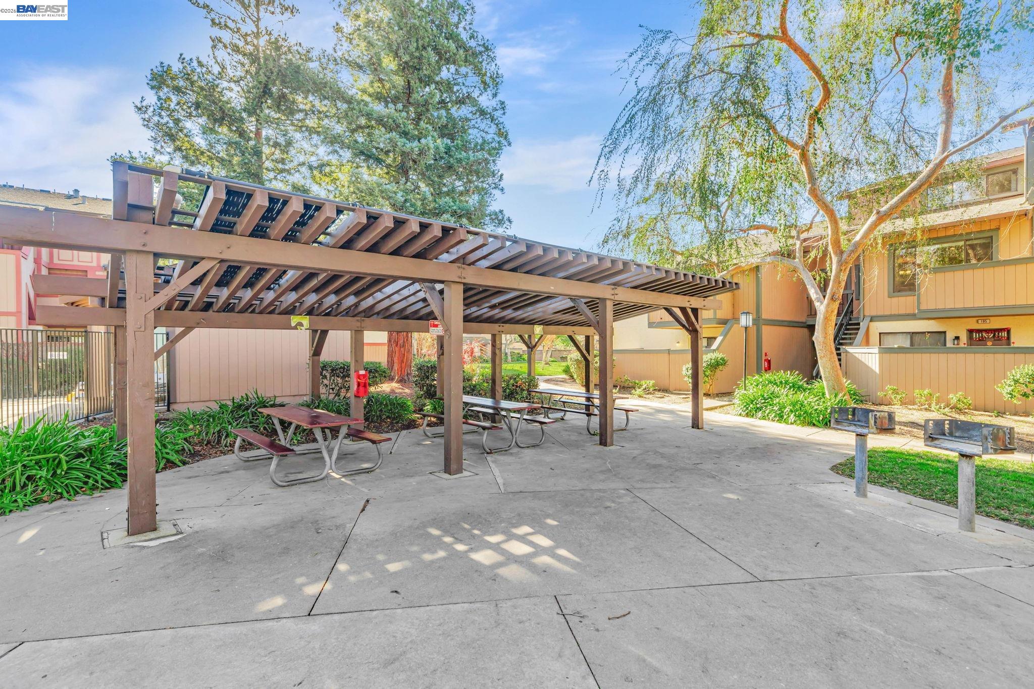 304 Hackamore Lane Fremont, CA 94539 - Photo 25 of 45 a view of a patio with a table and chairs under an umbrella