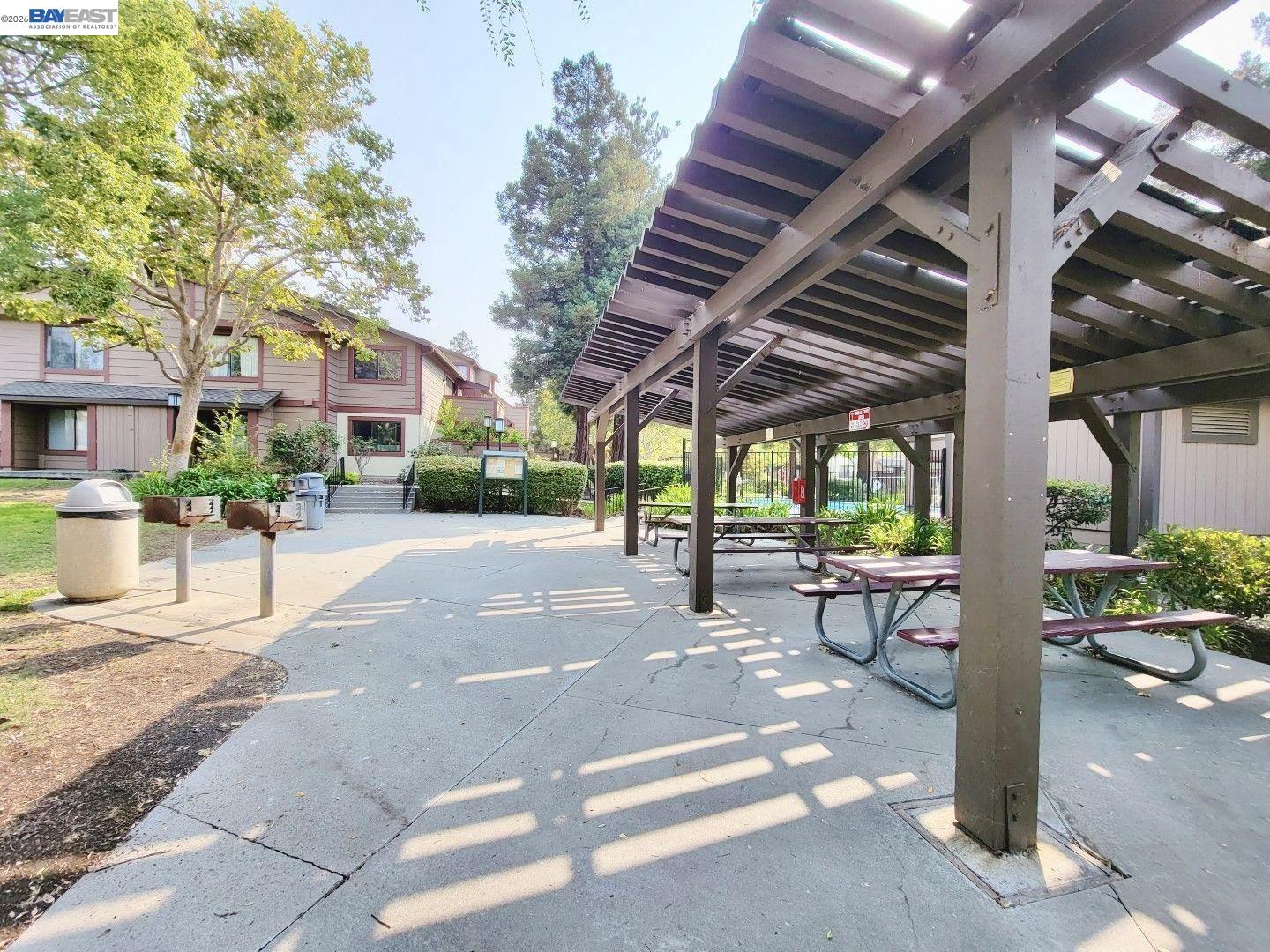 304 Hackamore Lane Fremont, CA 94539 - Photo 28 of 45 a patio with a table and chairs and potted plants