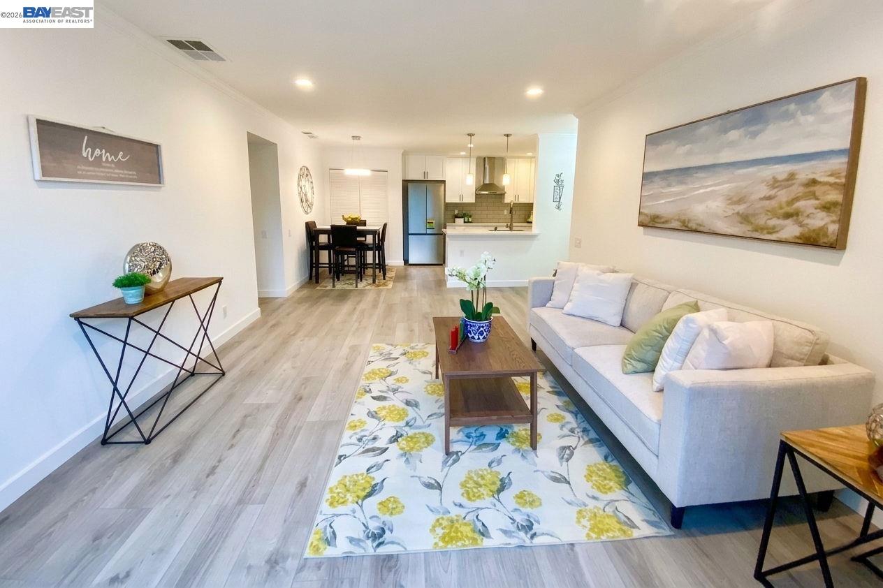 304 Hackamore Lane Fremont, CA 94539 - Photo 7 of 45 a living room with furniture and kitchen view with wooden floor