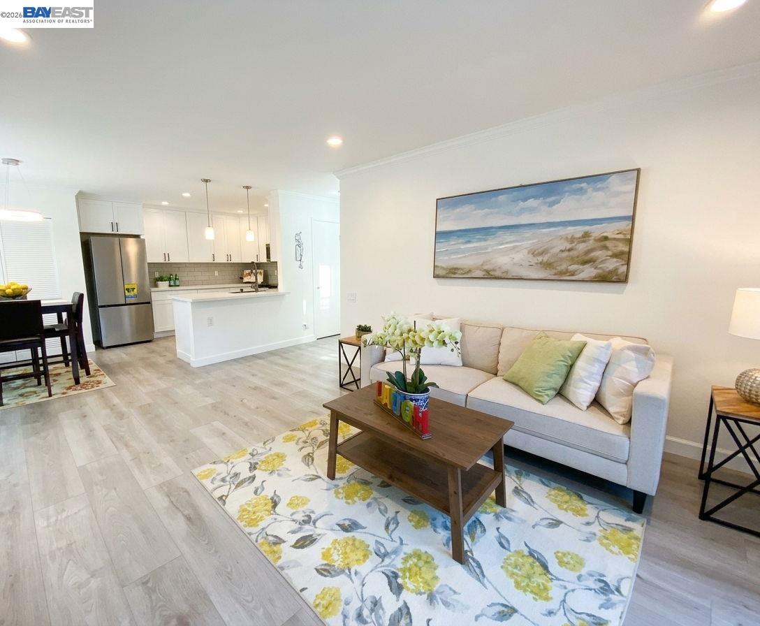 304 Hackamore Lane Fremont, CA 94539 - Photo 8 of 45 a living room with furniture and kitchen view with wooden floor