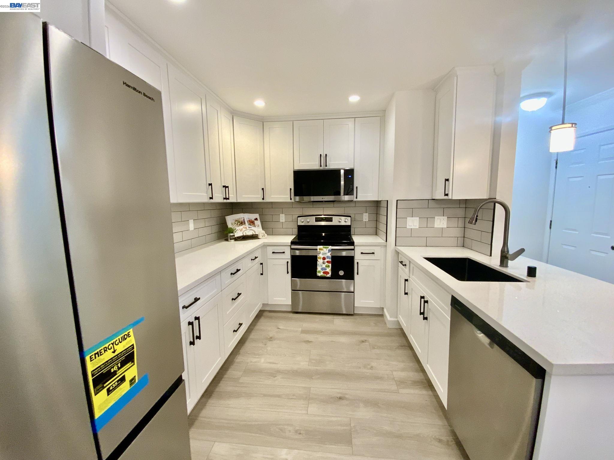 304 Hackamore Lane Fremont, CA 94539 - Photo 9 of 45 a large kitchen with stainless steel appliances kitchen island granite countertop a refrigerator a stove top oven a sink and dishwasher