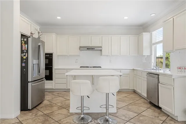 a kitchen with stainless steel appliances white cabinets and a granite counter tops