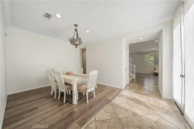 a view of a dining room with furniture and chandelier