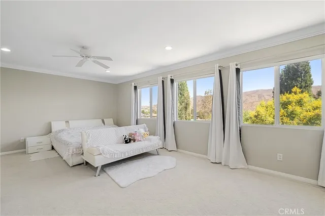a spacious bedroom with a bed and a window