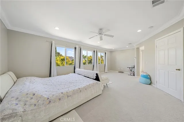 a bedroom with a large bed and window