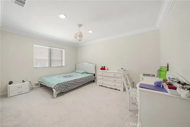 a bedroom with furniture and a chandelier