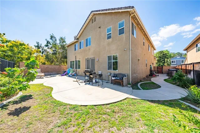 a view of a house with backyard and sitting area