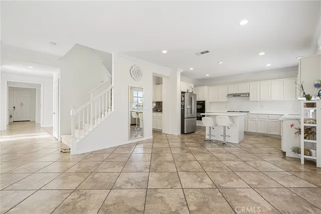 a view of open kitchen with white cabinets