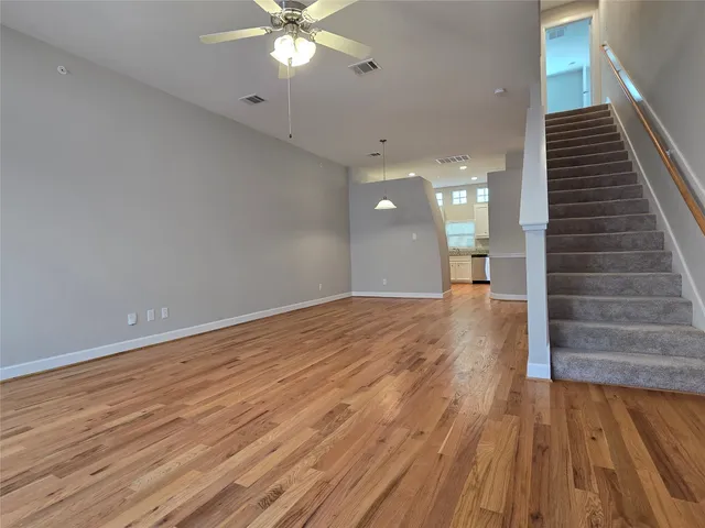 a view of a room with wooden floor and staircase