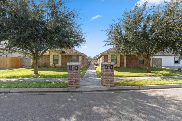 a front view of a house with a yard table and chairs