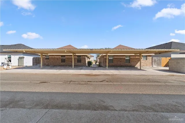 a front view of a house with a yard and mountain view