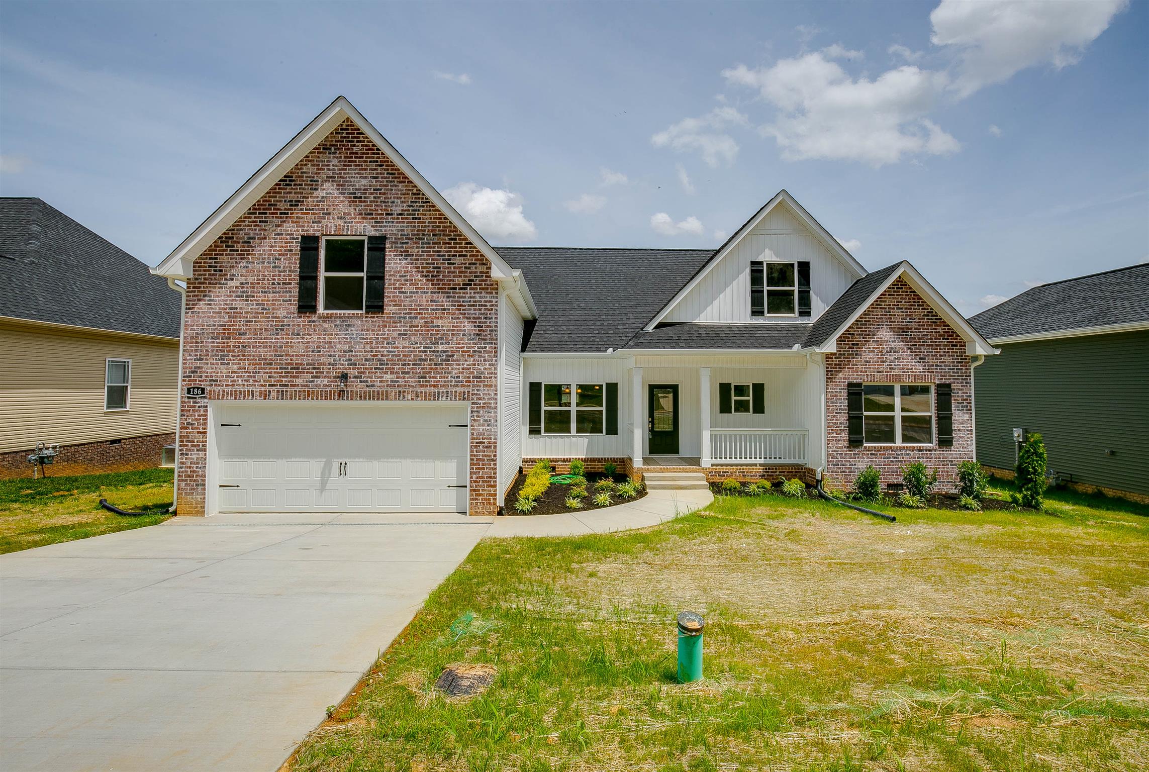 a front view of a house with a yard and porch
