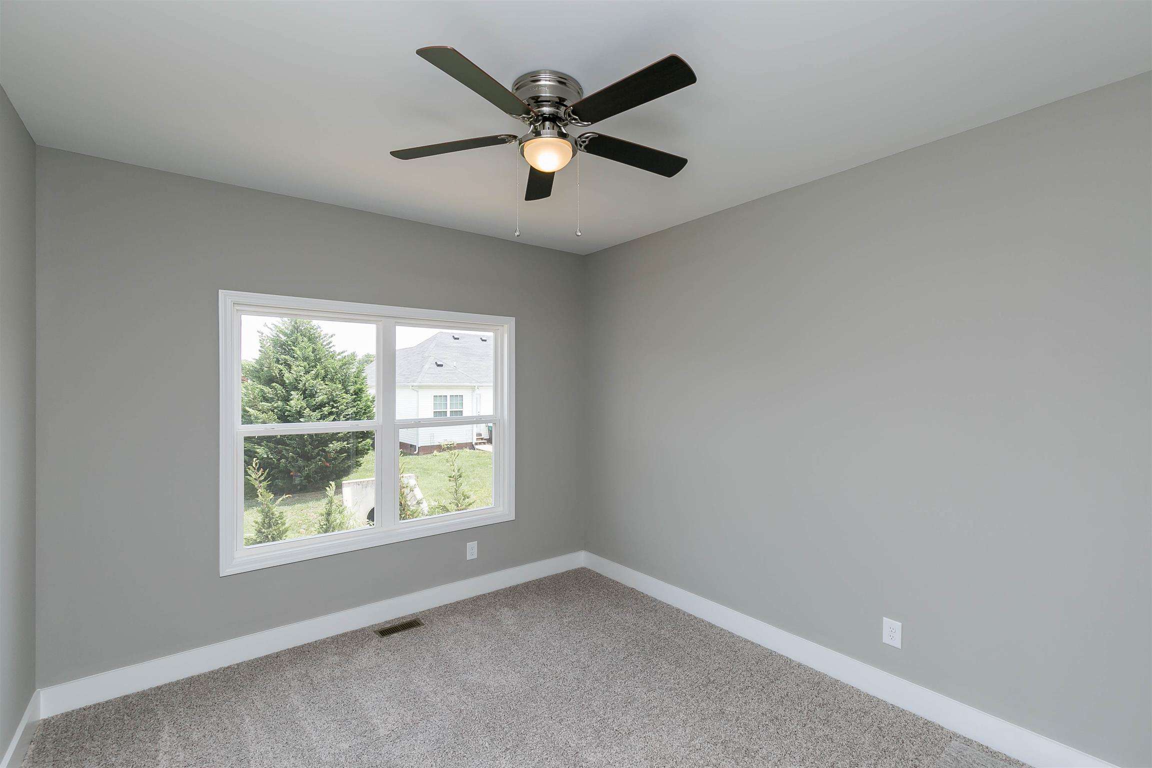 186 Fieldstone Lane Springfield, TN 37172 - Photo 18 of 22 an empty room with ceiling fan and windows