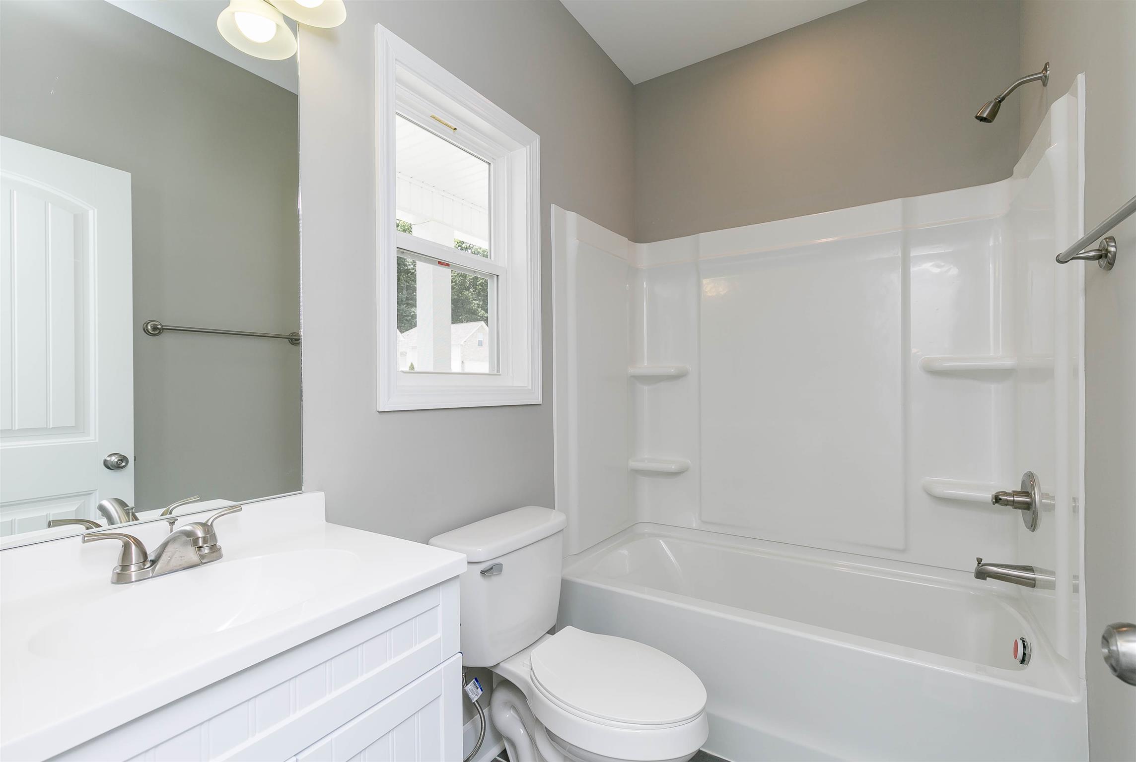 186 Fieldstone Lane Springfield, TN 37172 - Photo 20 of 22 a bathroom with a bathtub shower sink vanity mirror and toilet