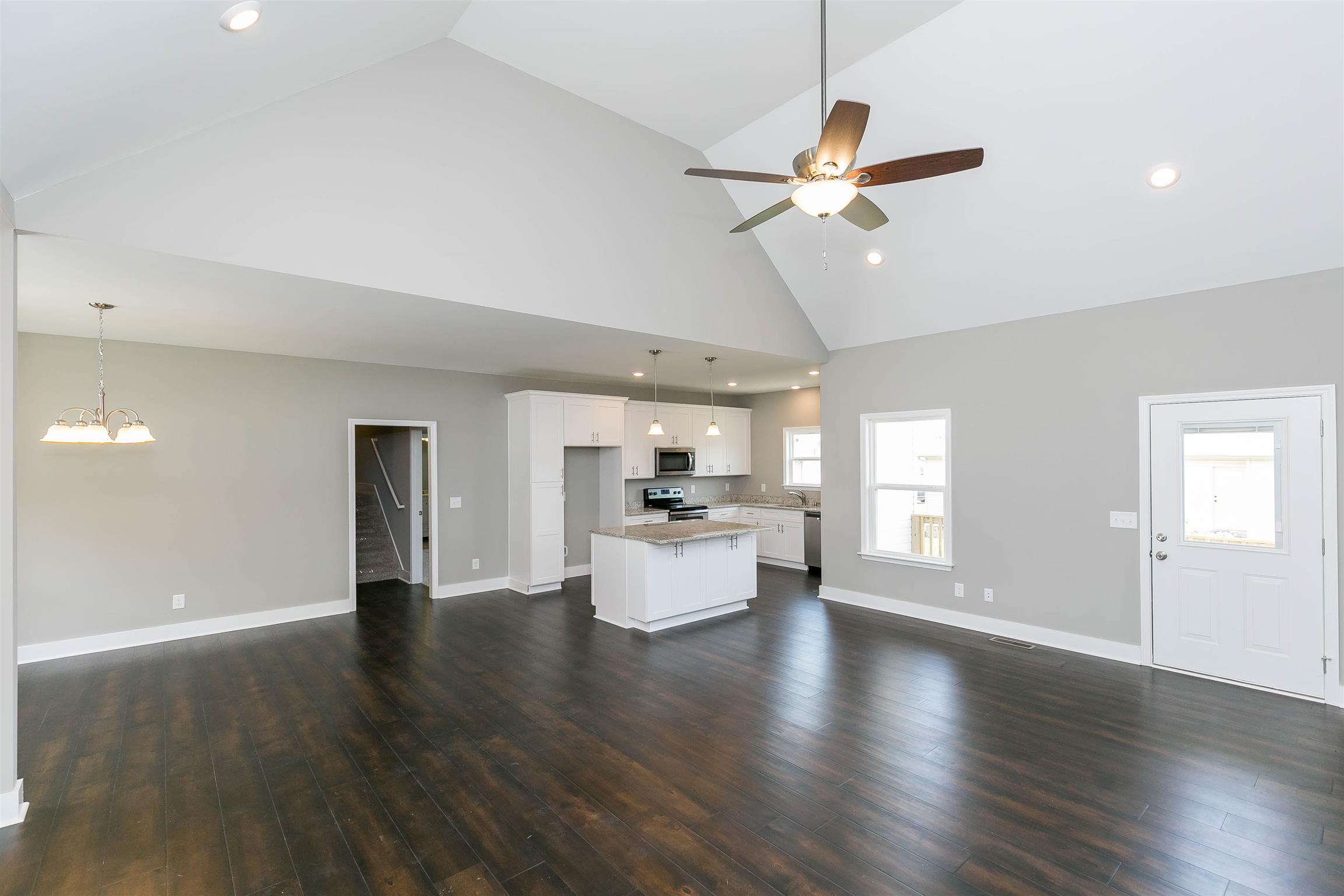 186 Fieldstone Lane Springfield, TN 37172 - Photo 6 of 22 a living room with couches and kitchen view with wooden floor