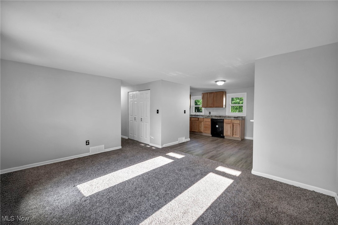 1135 Keefer Road Girard, OH 44420 - Photo 10 of 32 Unfurnished living room with baseboards and dark colored carpet