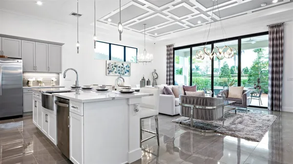a kitchen with a sink and living room