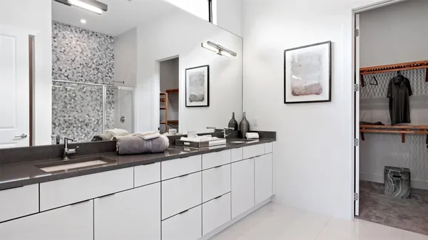 a bathroom with a double vanity sink and mirror