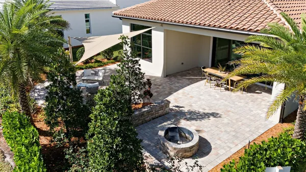 a backyard of a house with chairs and a yard