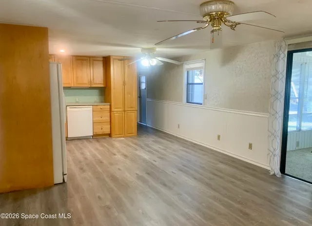a view of a kitchen with wooden floor
