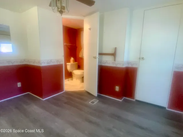 a view of a house with a yard and potted plants