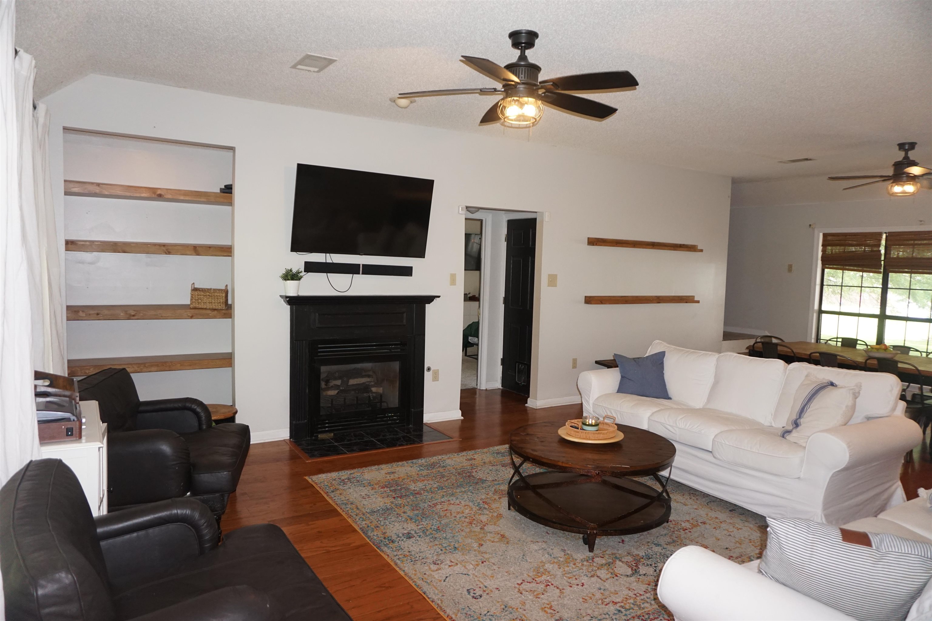 3780 Meade Lake Road Millington, TN 38053 - Photo 8 of 40 Living area featuring ceiling fan, a textured ceiling, wood finished floors, a fireplace with flush hearth, and baseboards