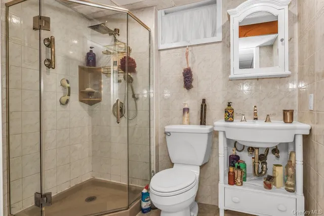 a view of a patio with table and chairs and potted plants with large tree