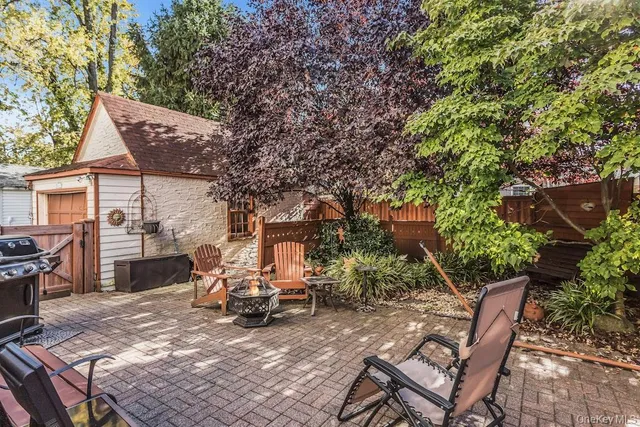 a view of a patio with table and chairs and potted plants