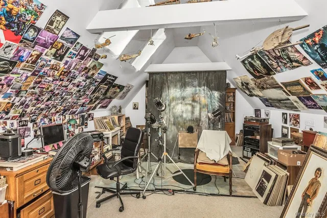 a living room with furniture fireplace and a window